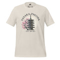 Cream shirt with the words Yasaka Pagoda in black arched over a Pagoda with a pink blooming tree to the left. Under, encased in dashes, in black text, reads "Est. 589 AD"