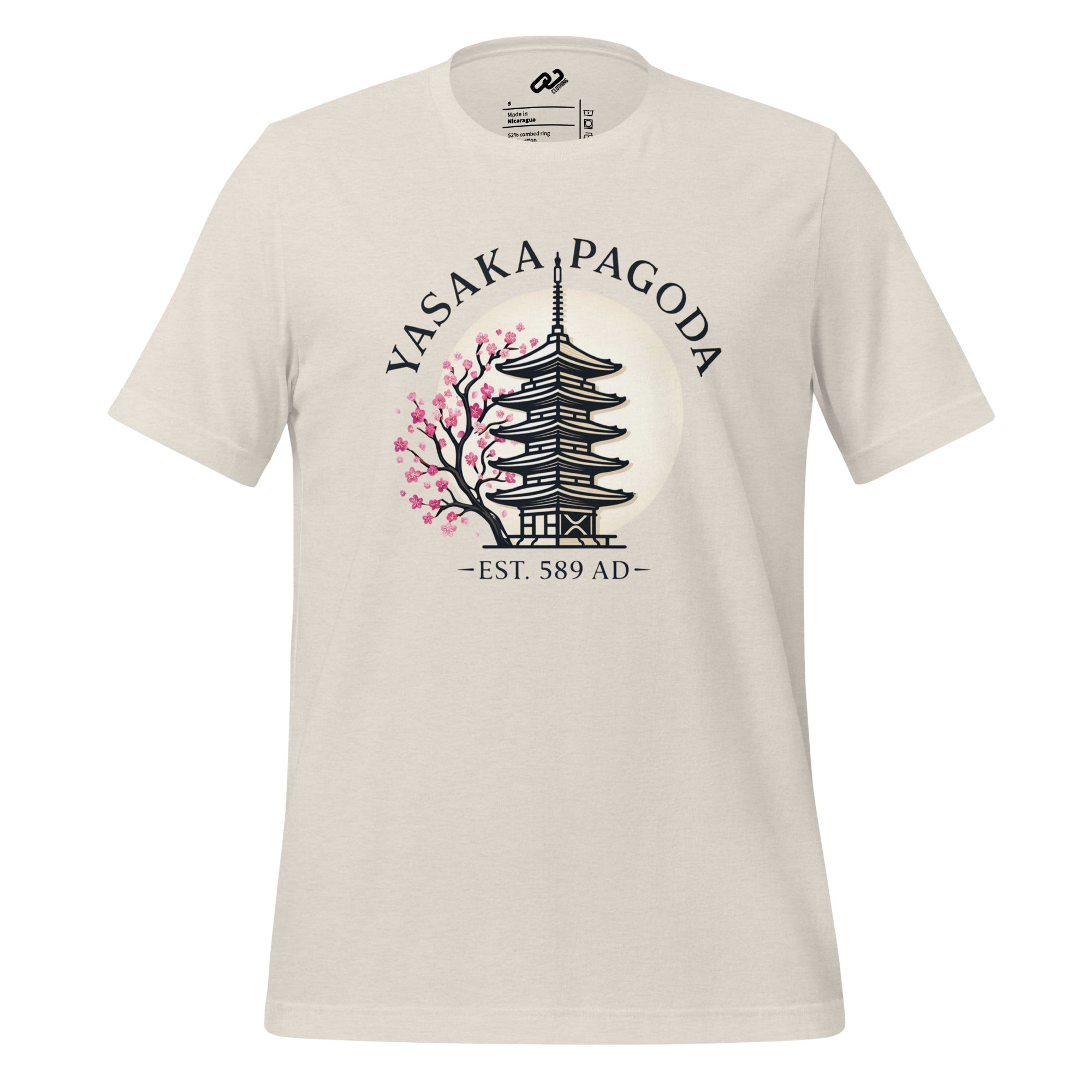 Cream shirt with the words Yasaka Pagoda in black arched over a Pagoda with a pink blooming tree to the left. Under, encased in dashes, in black text, reads "Est. 589 AD"